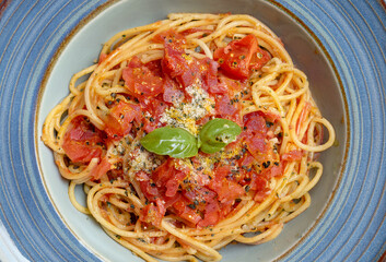A delicious plate of spaghetti with tomato sauce, garnished with fresh basil leaves.