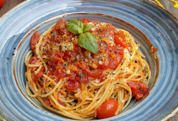 A delicious plate of spaghetti with tomato sauce, garnished with fresh basil leaves.
