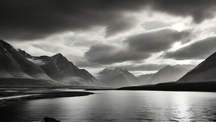 Monochrome Scenic View of Majestic Mountains and Serene Water Under Dramatic Sky