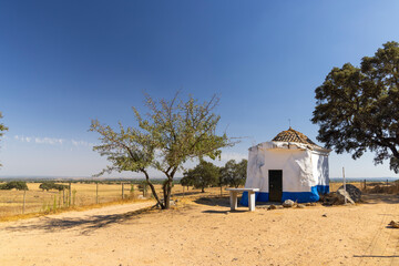 Small white chapel standing in the dry fields of Montemor o Novo, Portugal