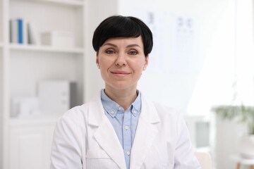 Portrait of professional ophthalmologist wearing uniform in clinic