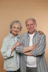 Portrait of lovely senior couple on beige background