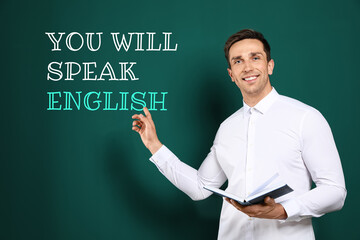 Teacher pointing at text You Will Speak English on green chalkboard. Language course