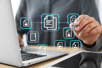 Woman working on laptop at table, closeup, Different document icons on virtual screen
