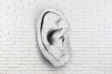 Human ear in white brick wall. Eavesdropping, concept that even walls have ears