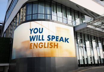 You Will Speak English text on digital billboard in city. Language course