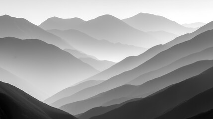 Monochromatic mountains receding into distance capturing depth with light and shadow