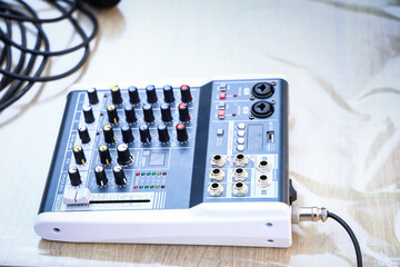 Top-down view of a professional audio mixer on wooden table. Concept of sound engineering, live...