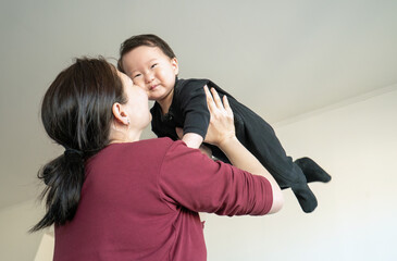 A woman is holding a baby in her arms