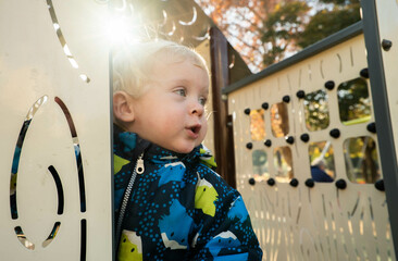 A small child on a playground in a park.