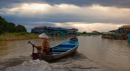 Tonle Sap lake, Siem reap Province, Cambodia. Fisherman in his boat, Floating village of Kompong...