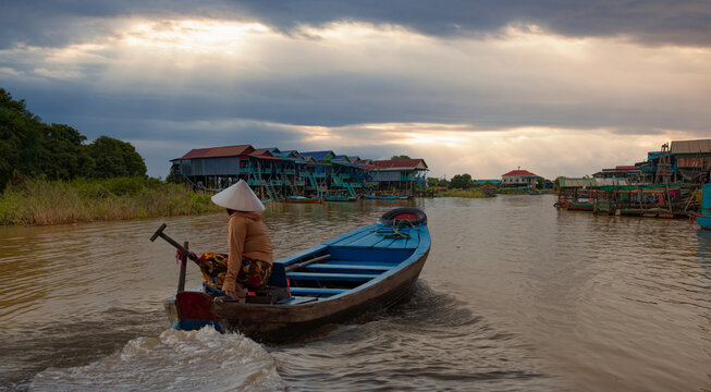 Fototapeta Tonle Sap lake, Siem reap Province, Cambodia. Fisherman in his boat, Floating village of Kompong Phluk, Cambodia.