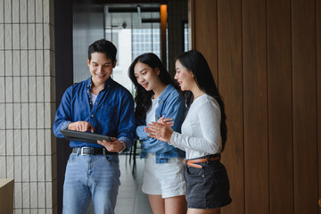 Young business team using tablet and discussing project in modern office