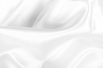 Smooth white silk fabric with gentle folds and flowing texture, ideal for luxury backgrounds,...