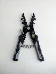 Open wire stripper and cutter tool showing its multifunctional jaws, isolated on a white background. Ready for electrical work or DIY project.