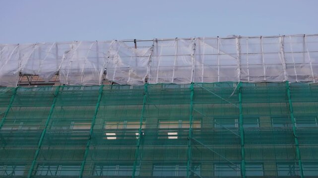 Construction Site Tarps Waving in Wind in high altitude, Urban Scene