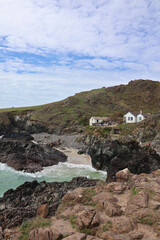Kynance Cove at high tide, Lizard Peninsula, Cornwall; sunny day and scenic coastal landscape with...