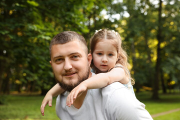 Fototapeta premium Happy Father's Day. Dad and his little daughter spending time together in park