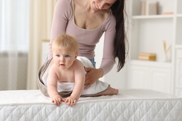 Mother with her cute baby at home, closeup