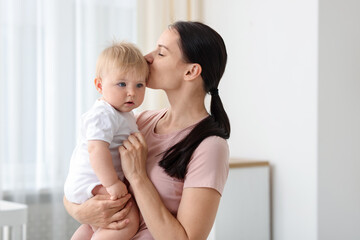 Mother with her little baby at home, space for text