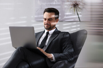 Professional psychologist having online consultation with his client via laptop indoors