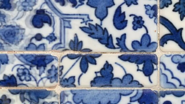 Intricate blue and white floral tile patterns provide an elegant, classic texture