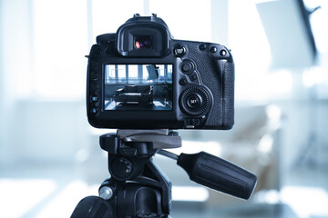 Shooting sofa with professional photo camera in studio, selective focus