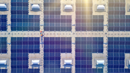 A bird's-eye view of a solar farm reveals rows of solar panels, symbolizing sustainable energy and...