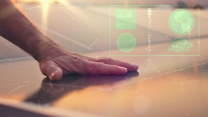 An elderly man's hand hovers over a touchscreen, symbolizing interaction with solar infrastructure...