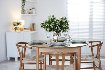 Bouquet of beautiful jasmine flowers on dining table indoors