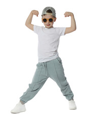 Cute little boy in sunglasses and baseball hat dancing on white background