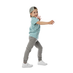 Happy little boy in baseball hat dancing on white background