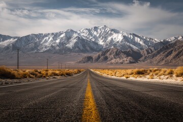 Open Road to Snowy Peaks A Journey Through Vast American Landscapes and Rugged Mountain Terrain under a Bright Blue Sky