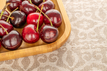 Sweet cherries on a wooden plate, macro.