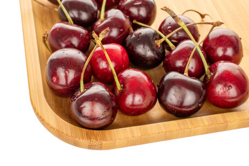 Sweet cherries on a wooden plate, macro.