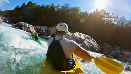 Two kayakers navigate churning rapids in a wild river, paddles slicing through frothy water, capturing the thrill and raw power of whitewater kayaking. © stockcopter