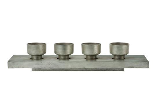 Four metallic cylinders arranged on a rectangular plate. Industrial, mechanical, or engineering concept.