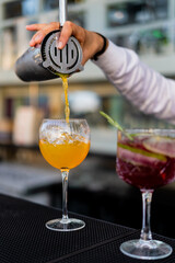 Bartender mixing and serving cocktails