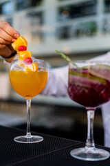 Bartender mixing and serving cocktails