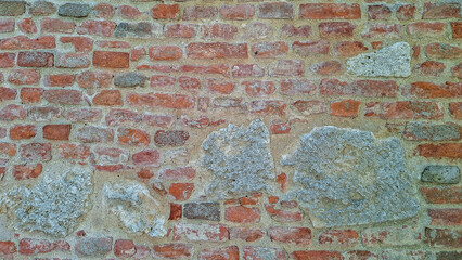 Textured Red Brick Wall with Stone Elements Design Patterns
