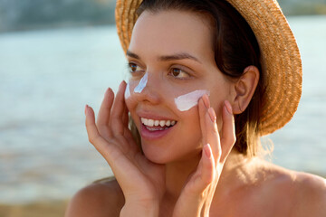 Suntan lotion woman applying sunscreen solar cream. Beautiful happy cute woman  applying suntan...