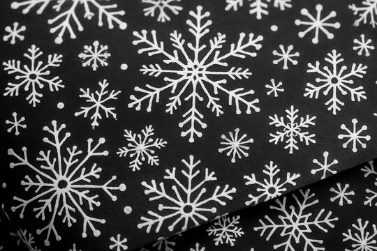 Riga, Latvia 05-09-2024 A close-up of a black fabric adorned with white snowflakes, evoking the chill and beauty of a snowy day