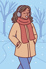 Dark skinned woman walks alone through snow-covered park wearing warm coat and scarf, enjoying quiet and peaceful winter scenery