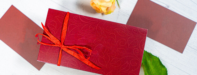 Vintage gift box package with blank gift tag on old wooden background.