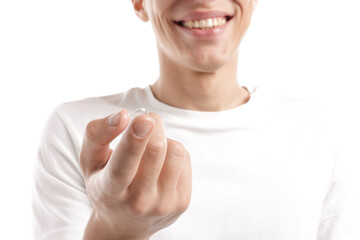 Man with contact lens on white background, closeup