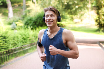 Sporty man with headphones running in park