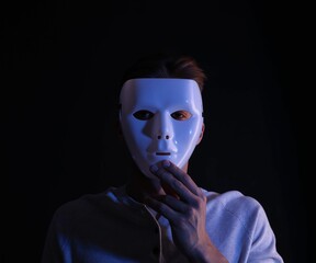 Anonymity. Man wearing mask on black background