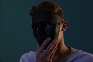 Anonymity. Man wearing mask on blue background
