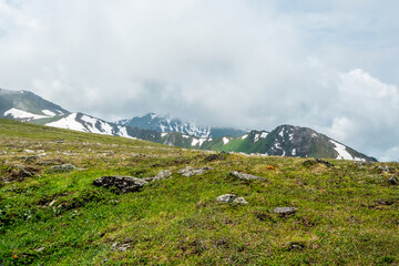 Rocky mountainside, contrast of stones and grass