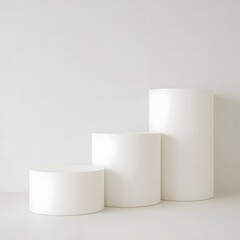 Photo of three white cylindrical stands are arranged in a row on a white background